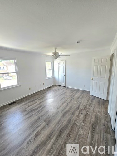 A white bathroom with a toilet, sink, and bathtub.