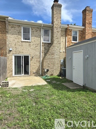 A house with a white door and a grey garage door.