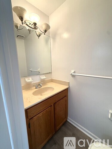 A bathroom with a sink and mirror.