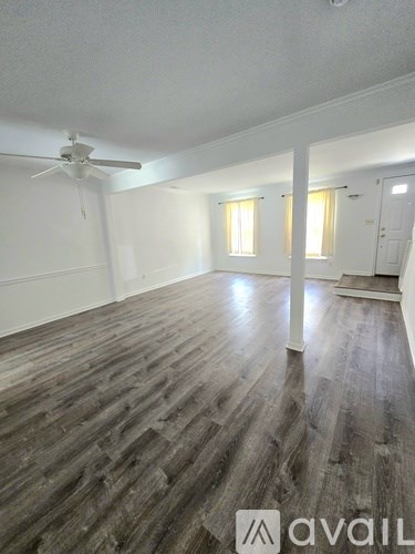 A house with a white door and windows with shutters.