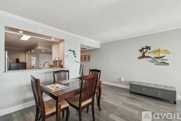 A dining room with a wooden table and chairs.