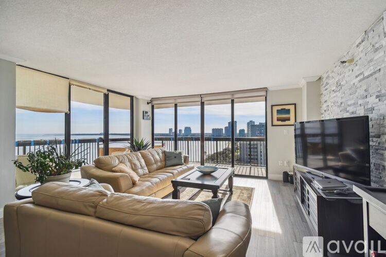 A living room with a large couch and a television.