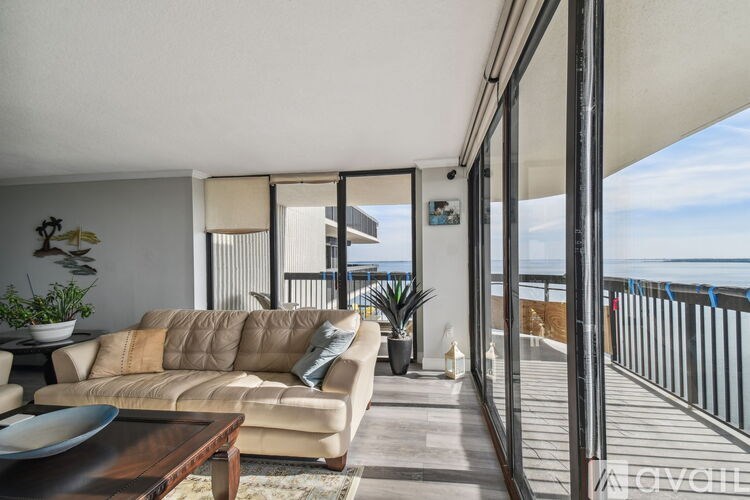 A living room with a couch and a table with a bowl on it.
