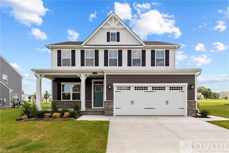 A two-story house with a garage is for sale.