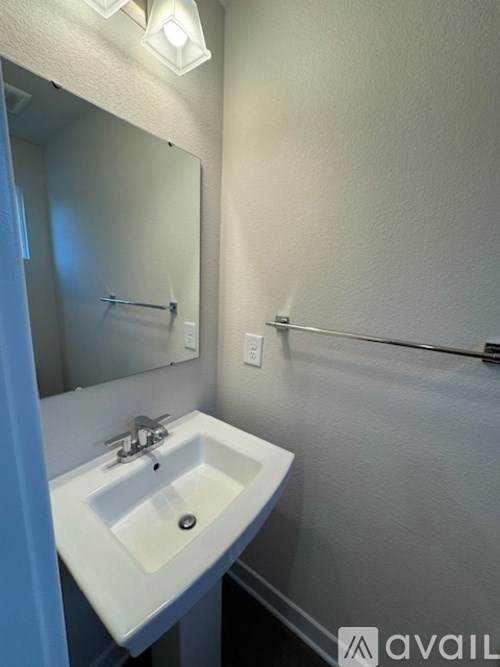 A bathroom with a sink and mirror.