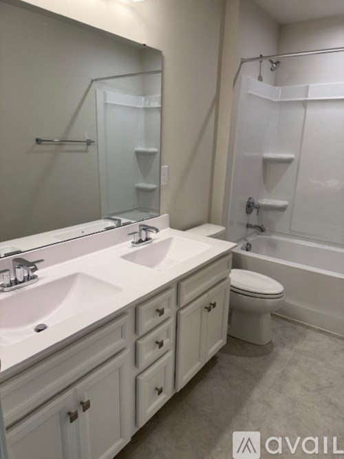 A bathroom with a white sink and toilet.
