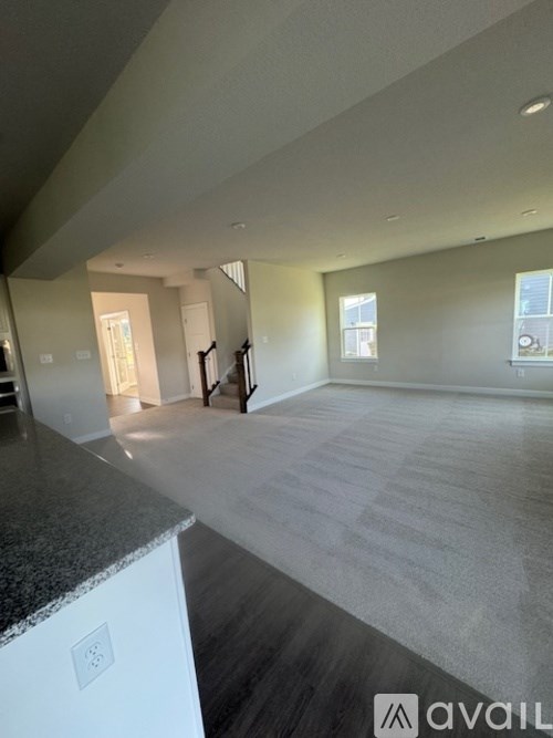 A spacious room with a marble countertop and carpeted floor.