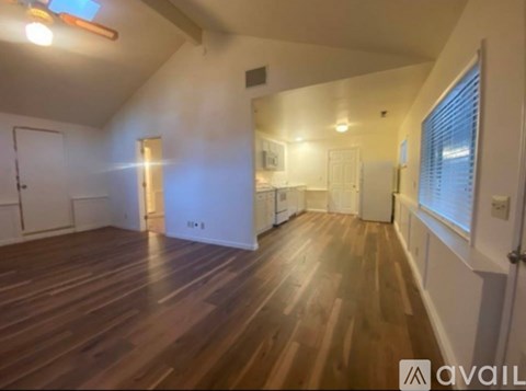 A kitchen with a refrigerator, sink, and oven.