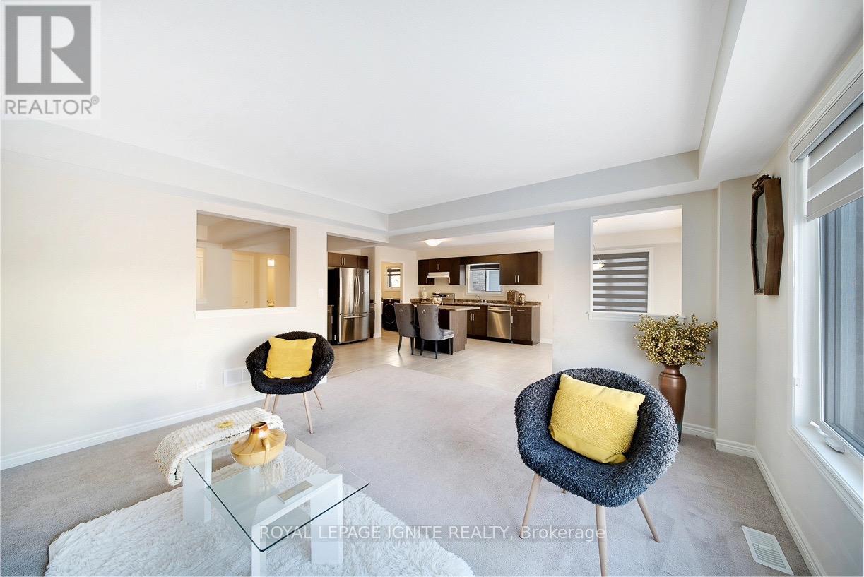 A living room with a white couch and a yellow pillow.