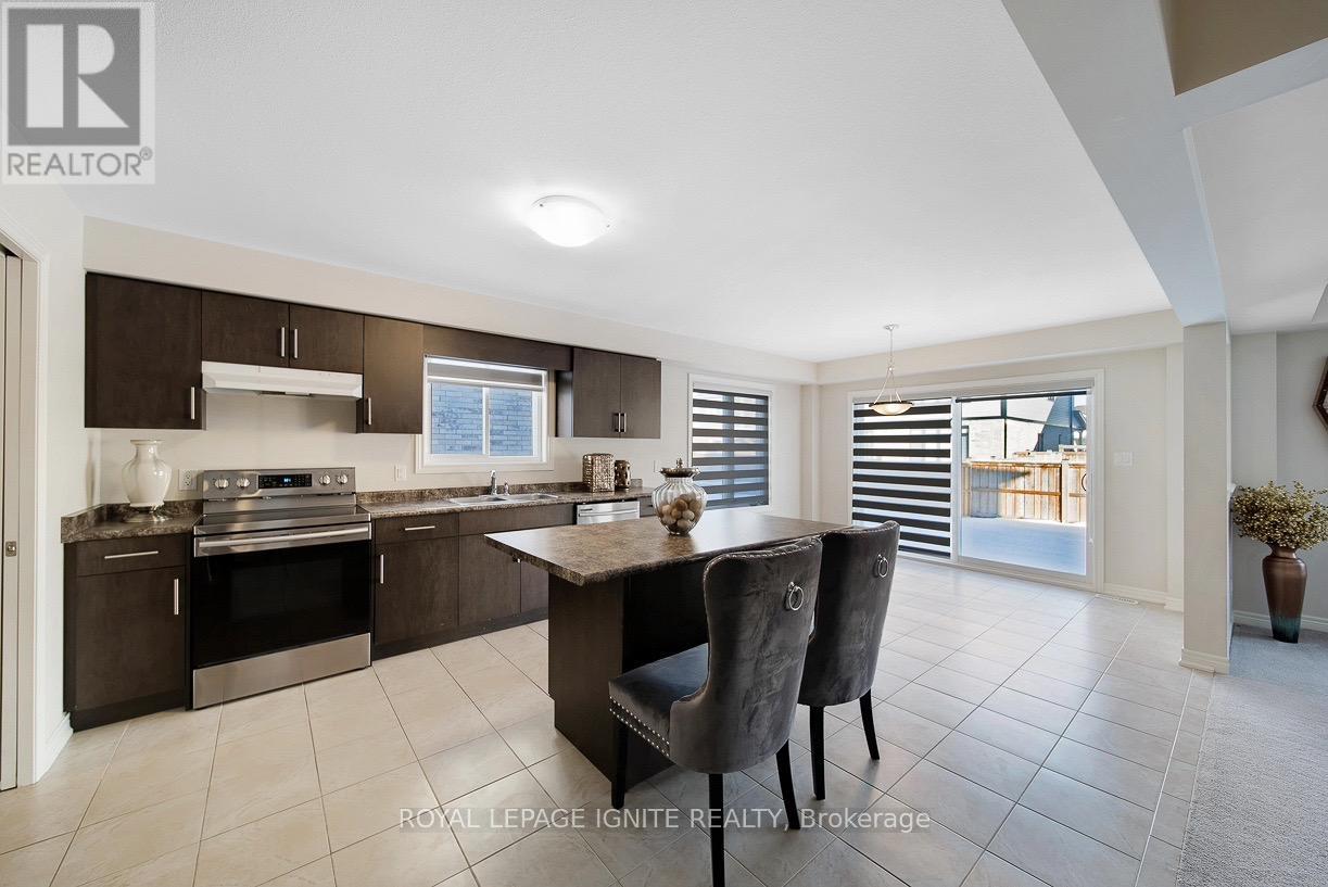A modern kitchen with a dining table and chairs.
