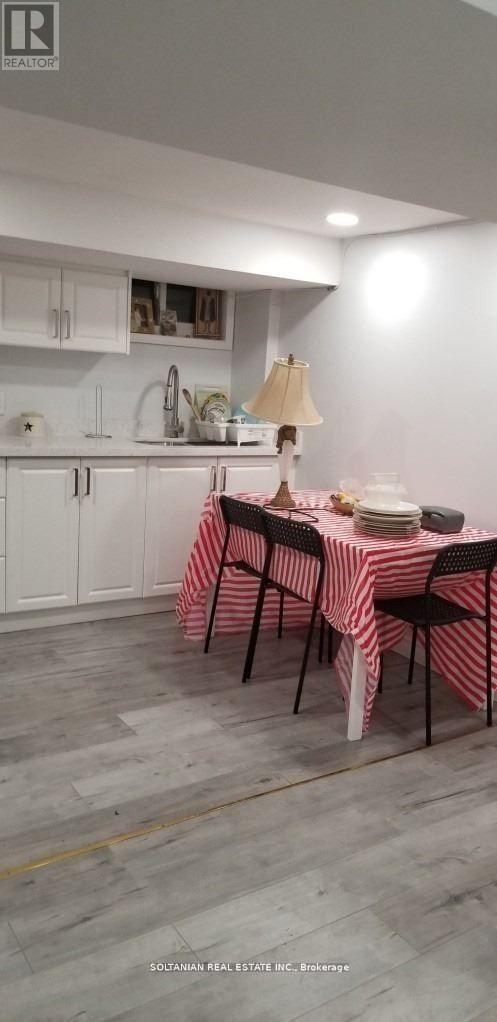 A dining room with a table set for a meal.