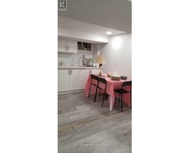 A dining room with a table set for a meal.