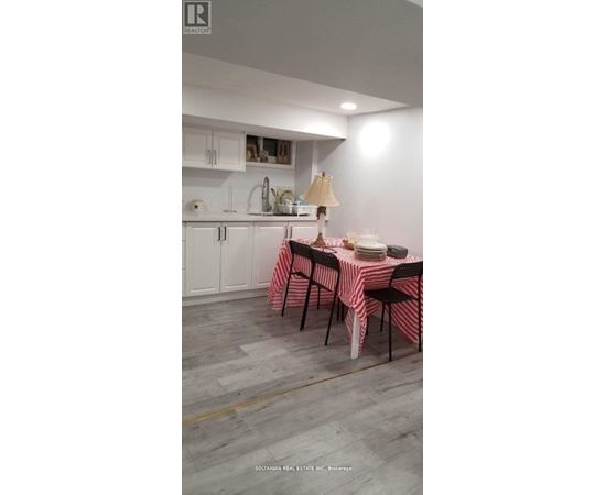 A dining room with a table set for a meal.