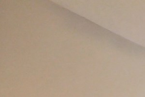 264 an empty living room with a ceiling fan and a window