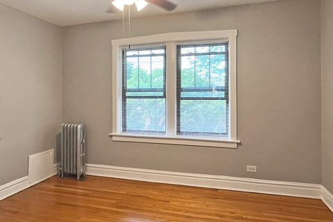 A room with a window and a fan.
