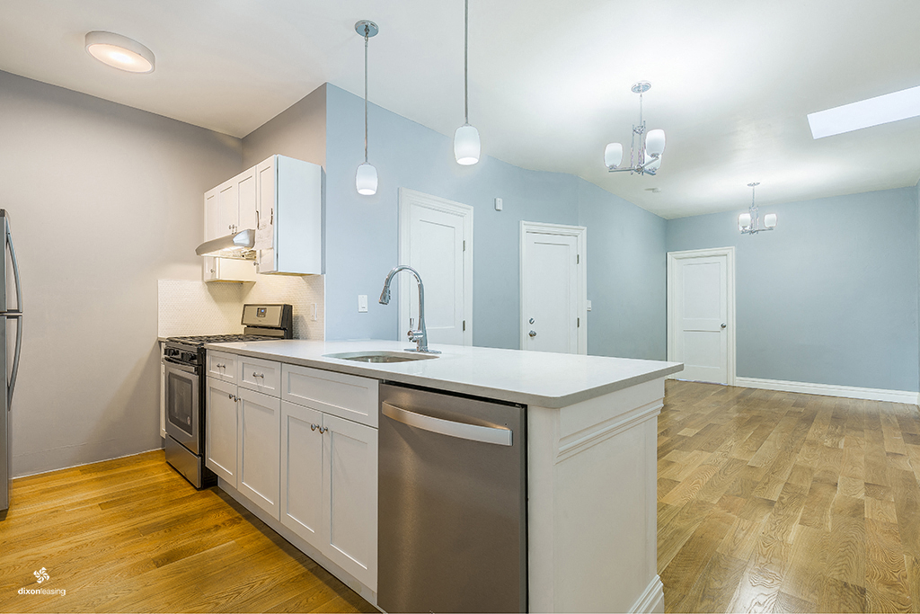 a kitchen with an island and stainless steel appliances