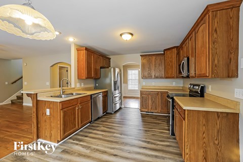 A kitchen with wooden cabinets and a sink.