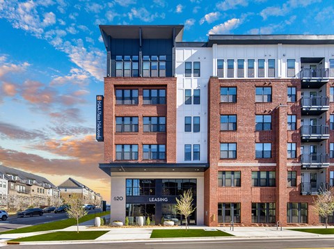 A modern multi-story building with a leasing office at the ground level.