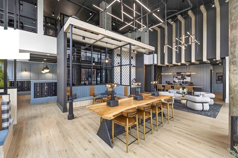 A modern dining area with a long wooden table and chairs.
