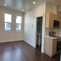 A kitchen with a microwave on the counter.