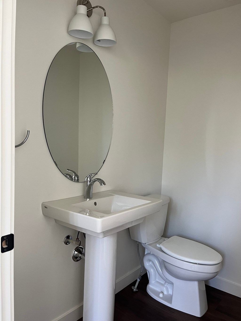 A white sink and toilet in a bathroom.