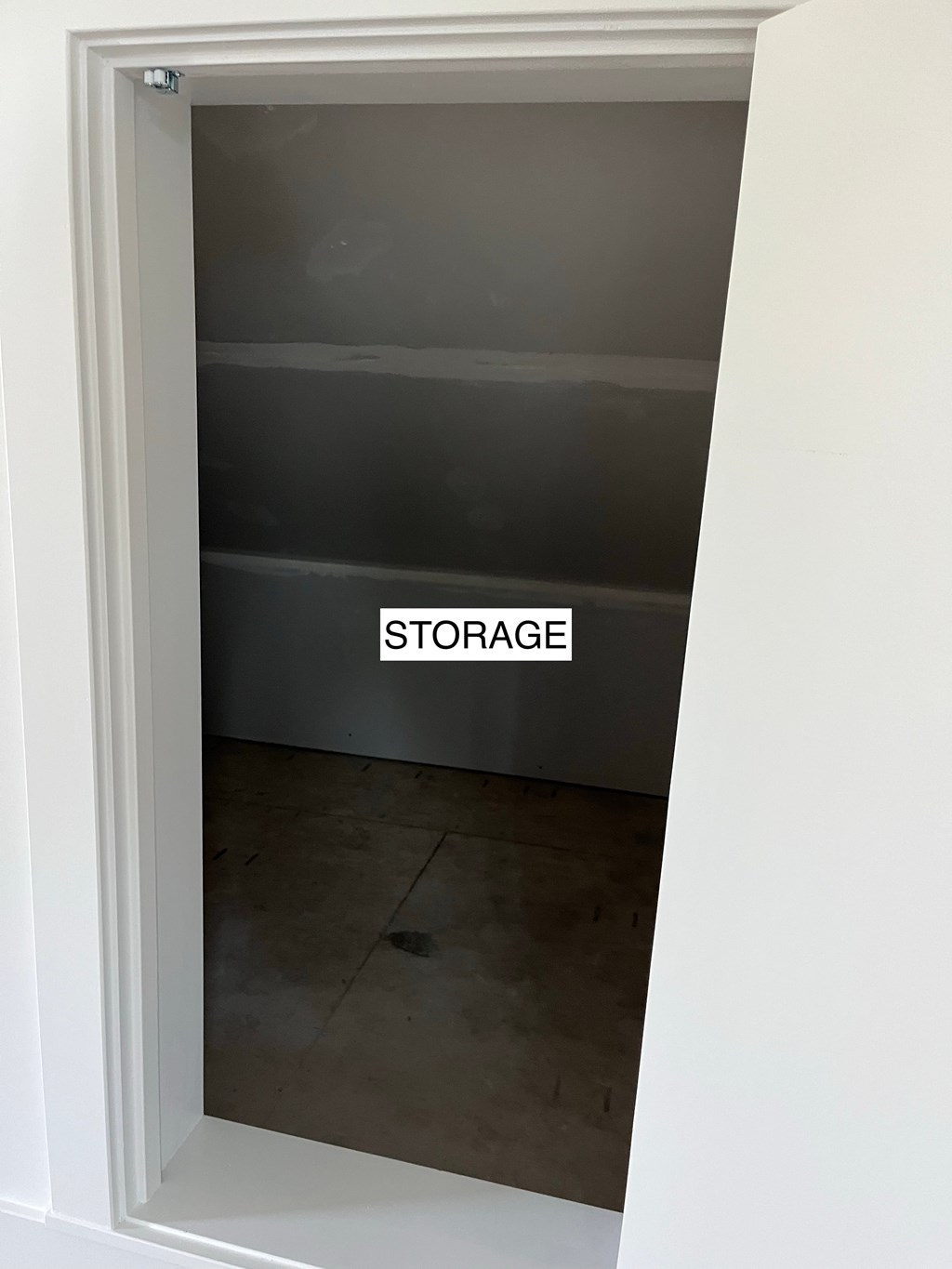A storage room with a glass door and a sign on it.