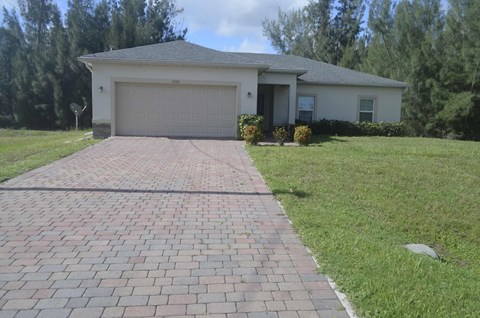 A house with a driveway in front of it.