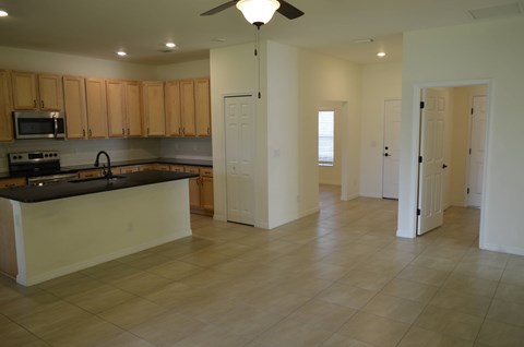 A kitchen with wooden cabinets and a black countertop.