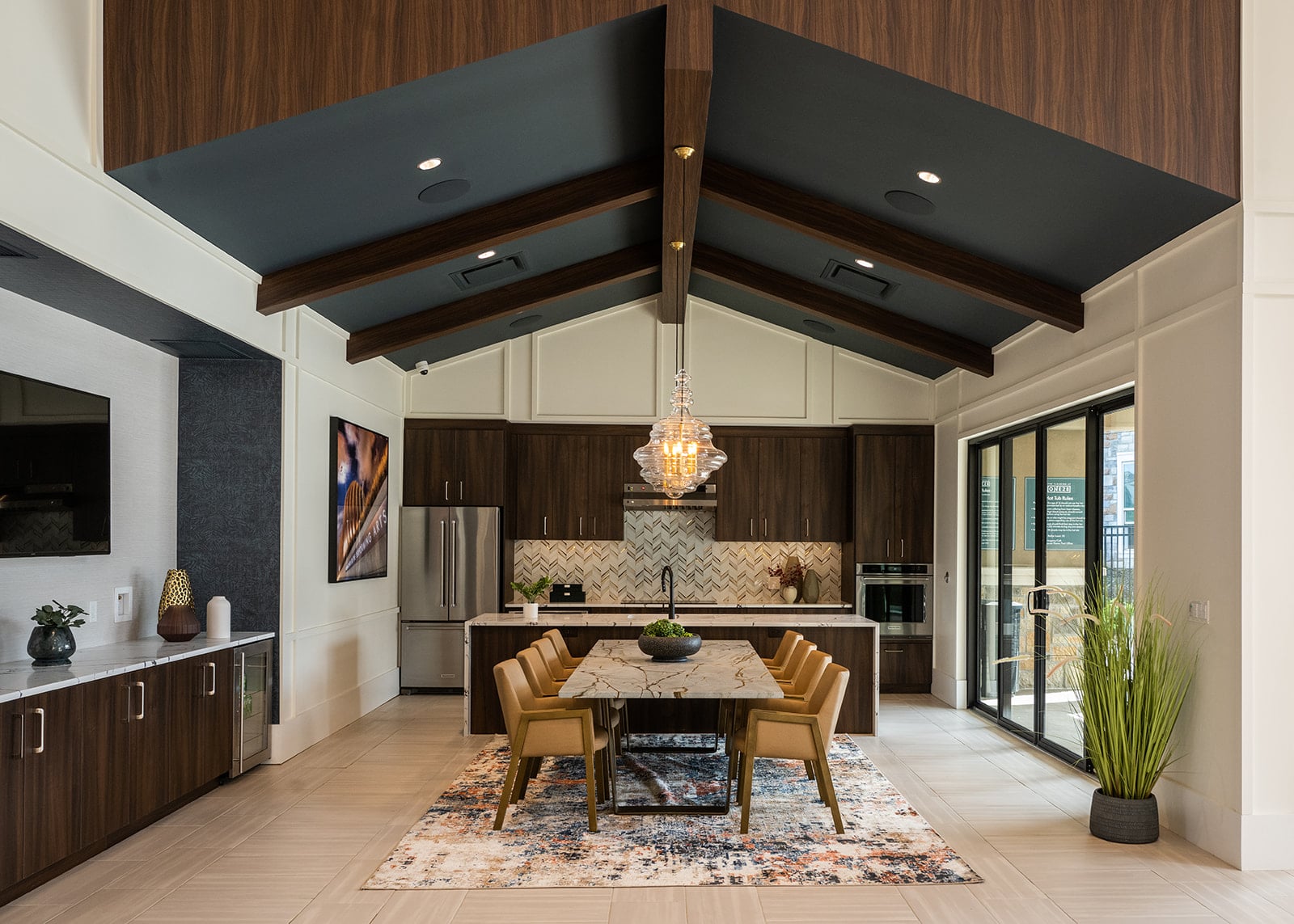 A modern kitchen with a dining table and chairs.