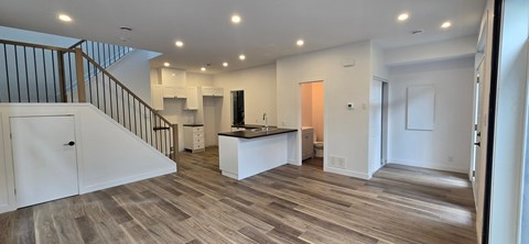A spacious open floor plan with a kitchen and living room.