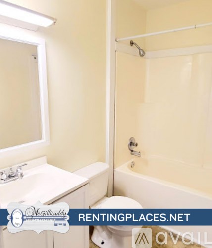 A room with wooden floors and a white door.