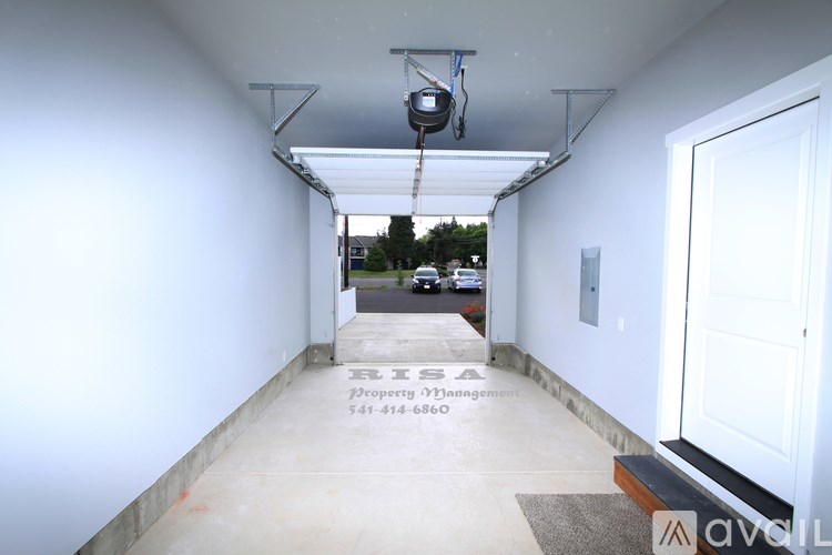 A long hallway with a sign that says "EISA Property Management 541-414-6860".