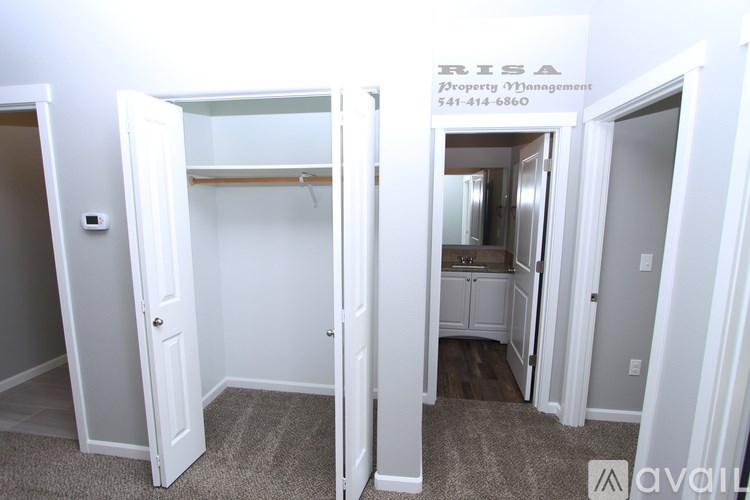 A sign for RISA Property Management is on the wall of a white room.