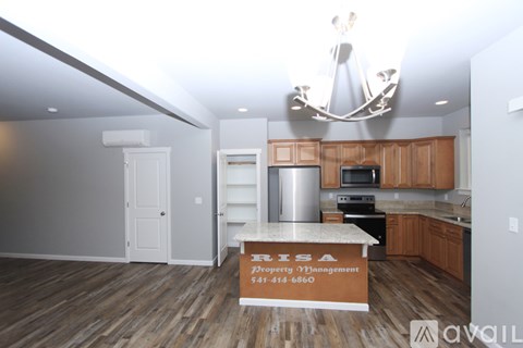 A kitchen with a counter that says "PRISA Property Management" on it.