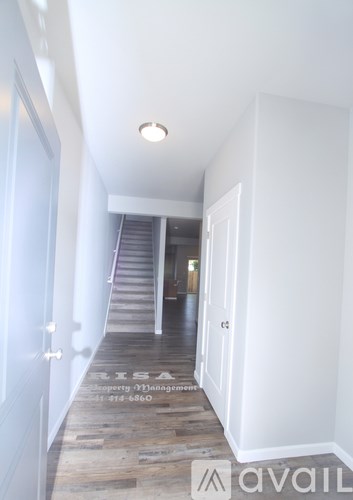 A hallway with a staircase leading to the second floor.