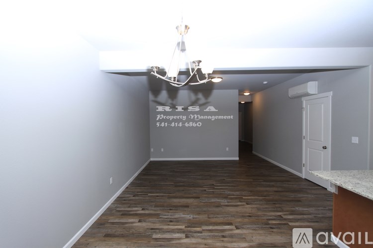 A room with wooden floors and a chandelier.