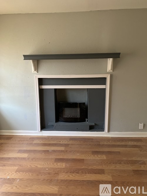 A fireplace with a white mantle and a grey hearth.