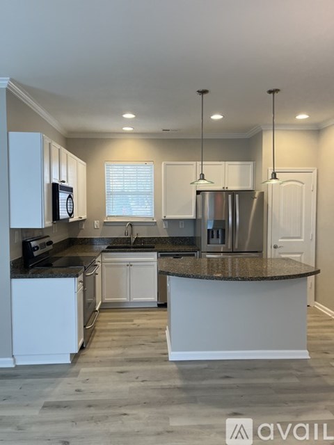 A kitchen with granite countertops and stainless steel appliances.