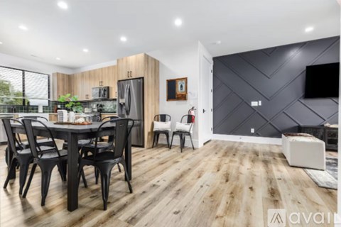 A modern kitchen with a dining table set for four.