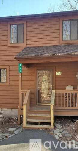 A wooden house with a porch and a sign that says 350.