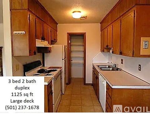 A kitchen with wooden cabinets and a large deck.