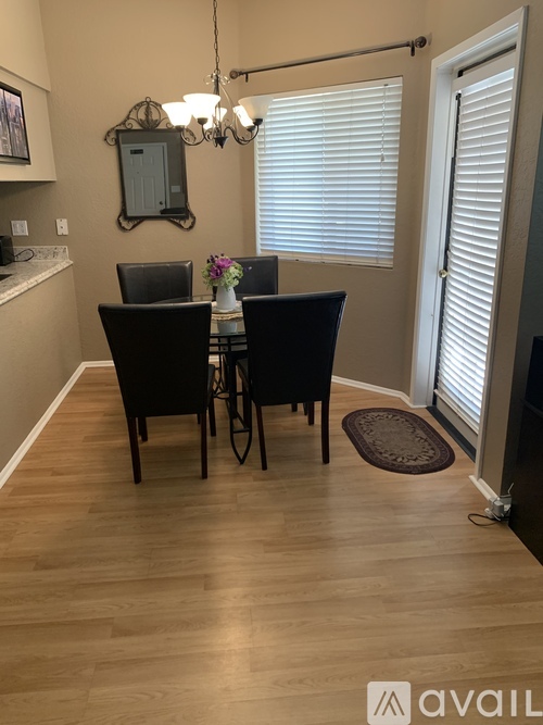 A dining room with a table set for two.