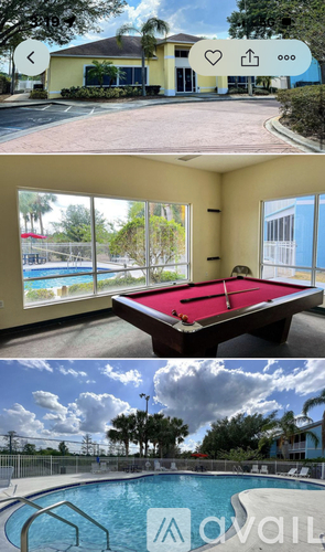 A pool table in a room with a view of the pool.