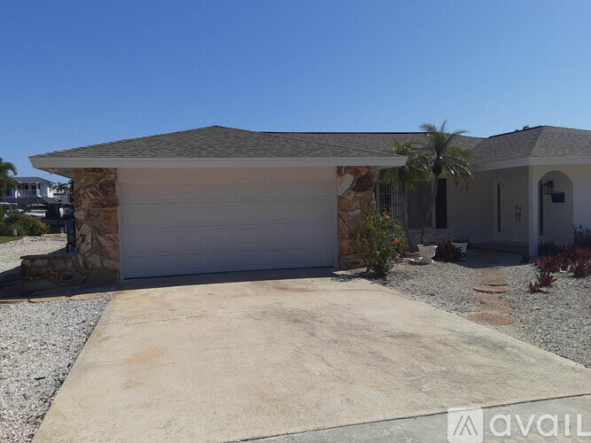 A house with a garage and a driveway in front.