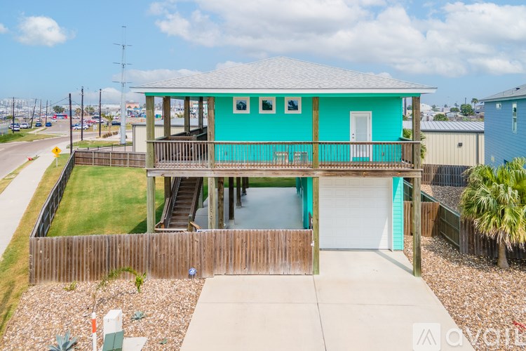 A blue house with a white door and windows.