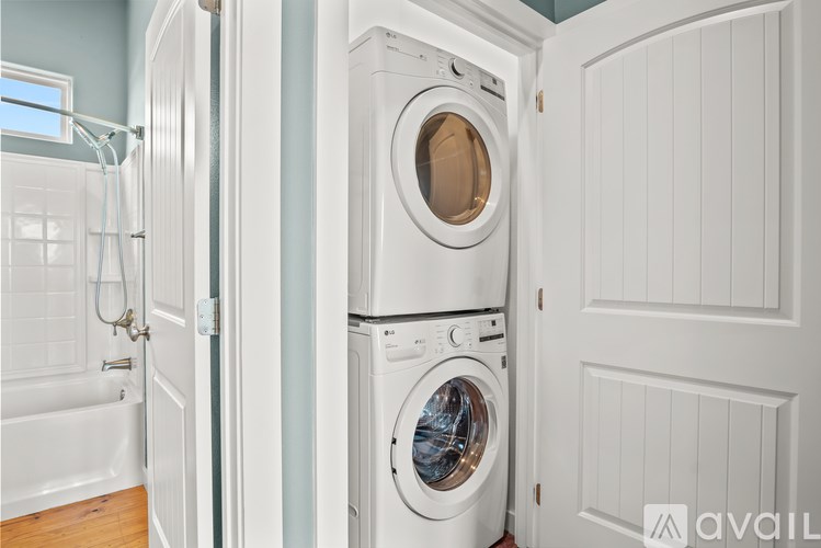 A white washing machine and dryer in a laundry room.