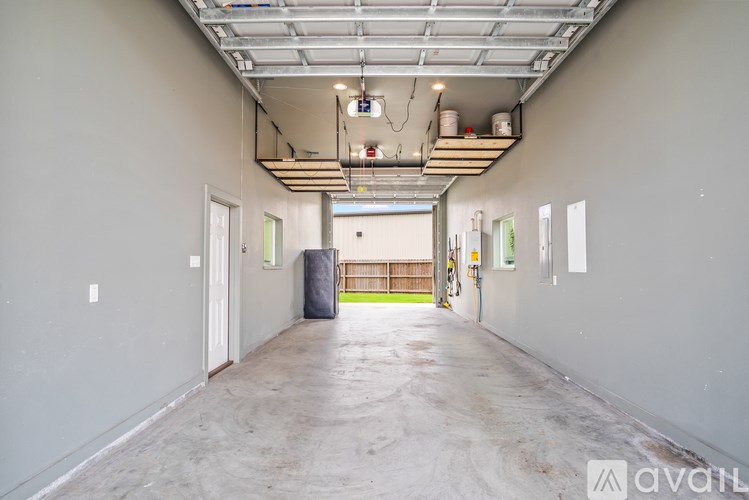 A large empty room with a concrete floor and a metal ceiling.