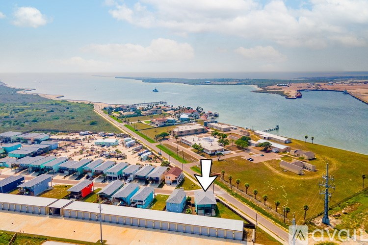 A large industrial area with a body of water in the background.