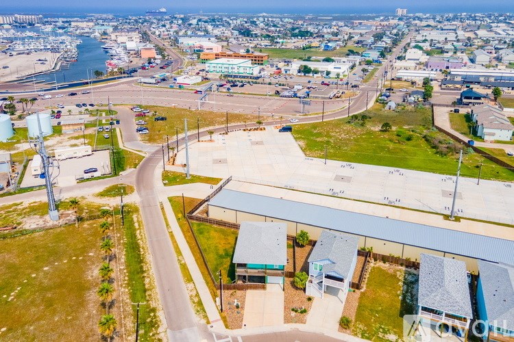 A bird's eye view of a city with a large body of water in the background.