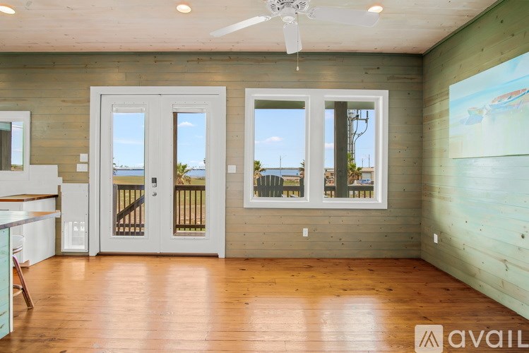 A room with wooden walls and a ceiling fan.